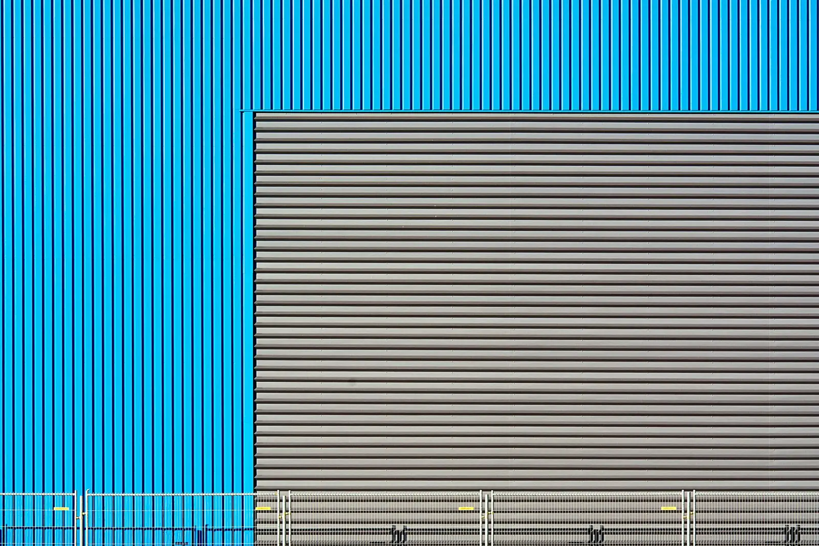 Blue profiled wall with a grey insulated door panel