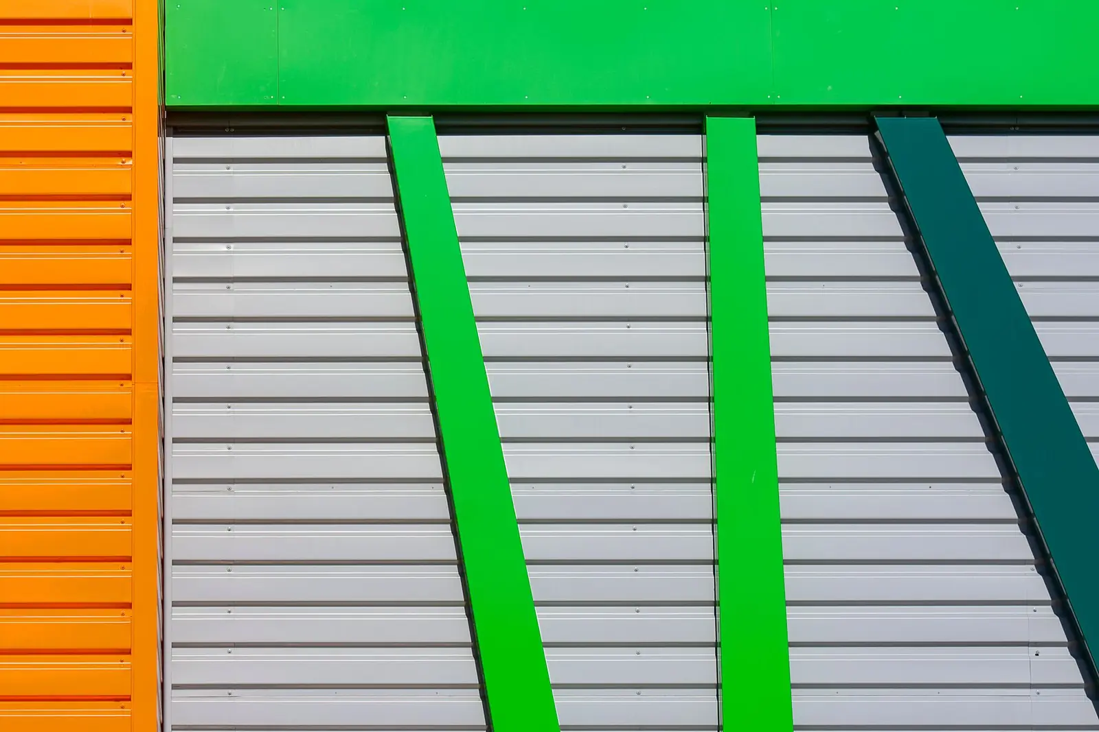 Orange, green and grey insulated panels on a facade