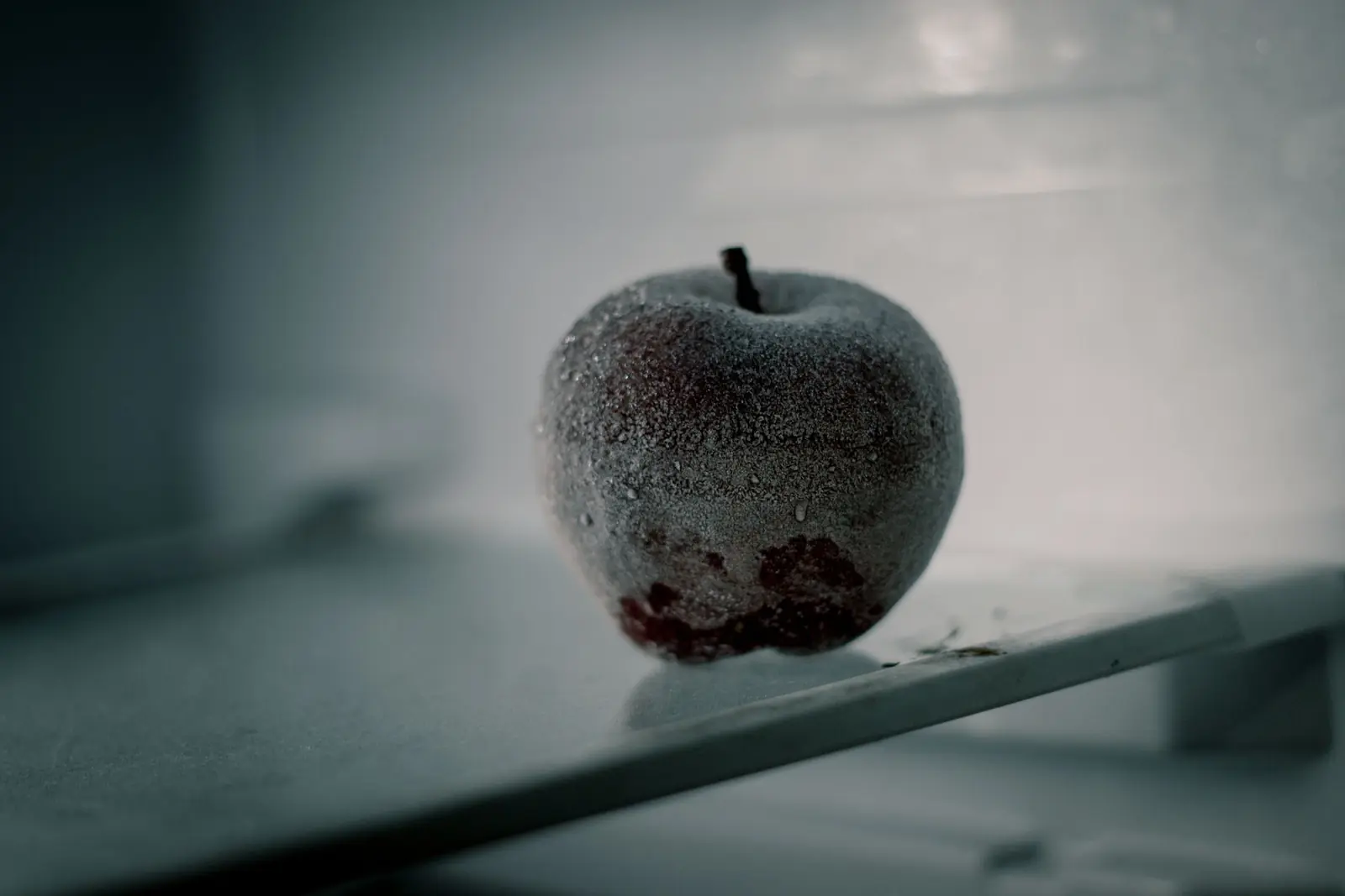 Frosted apple on a shelf in cold storage