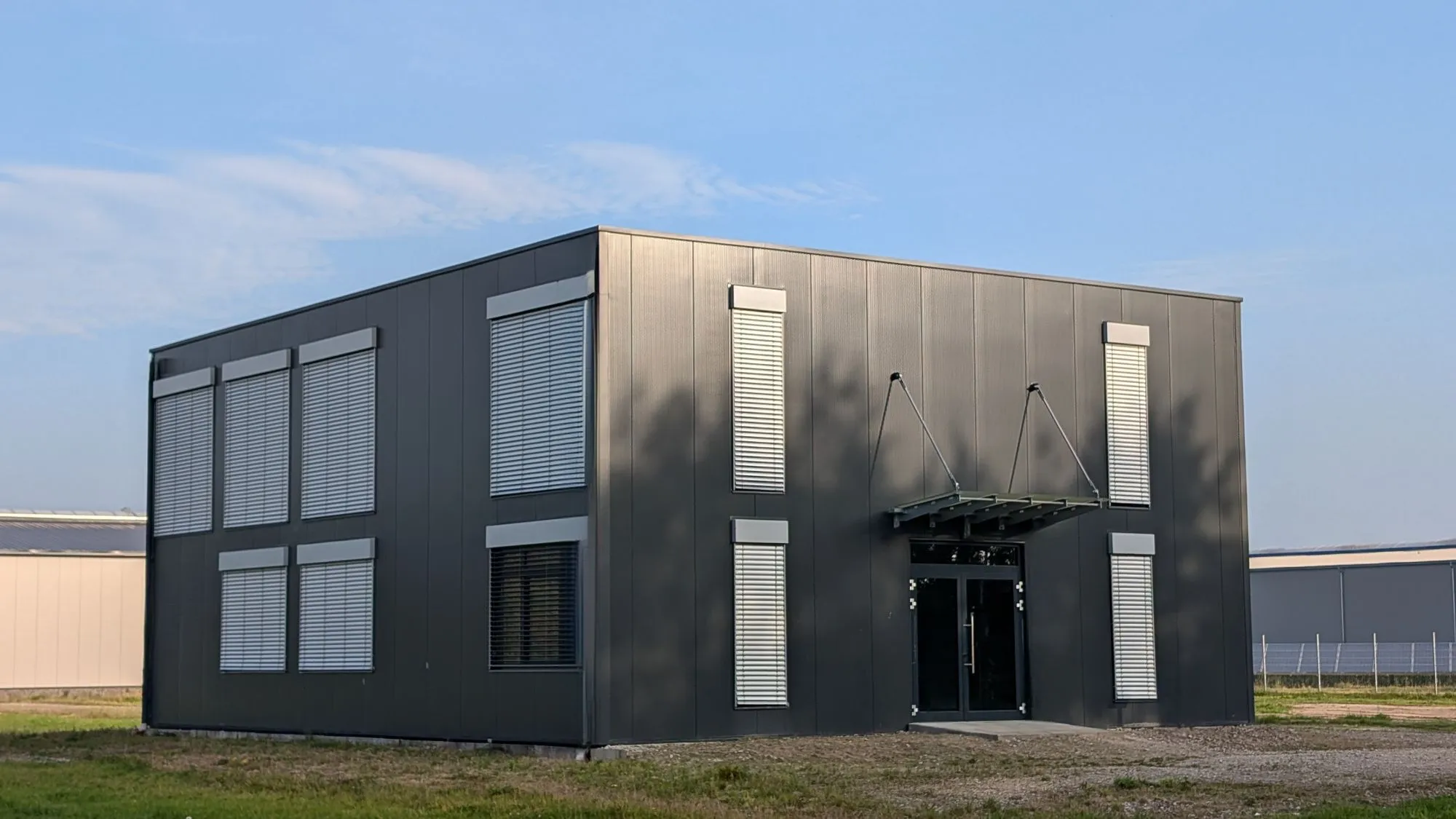 Building clad in dark insulated wall panels