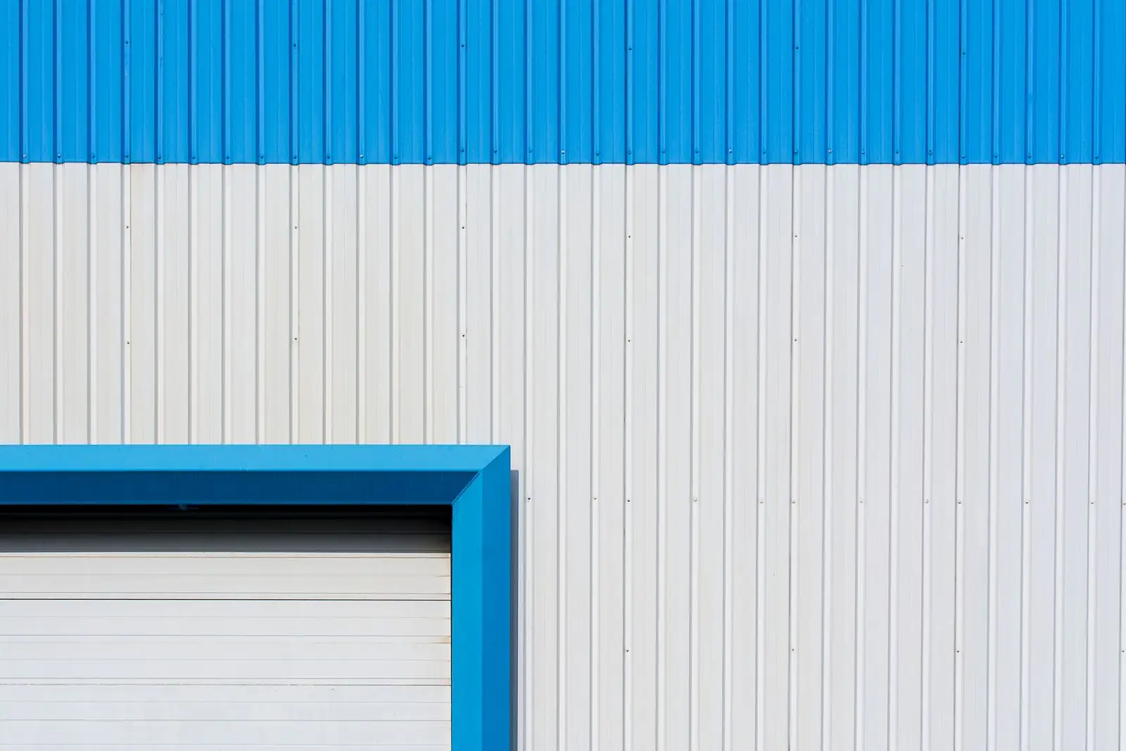Blue and white profiled panel wall with roller door