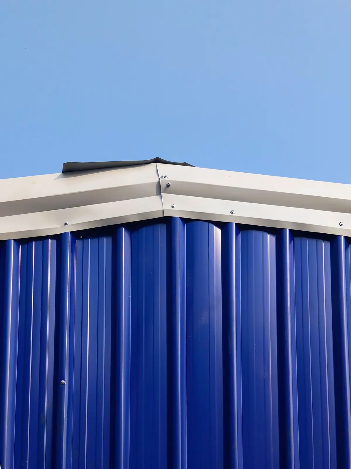 Roof edge of a blue panel building