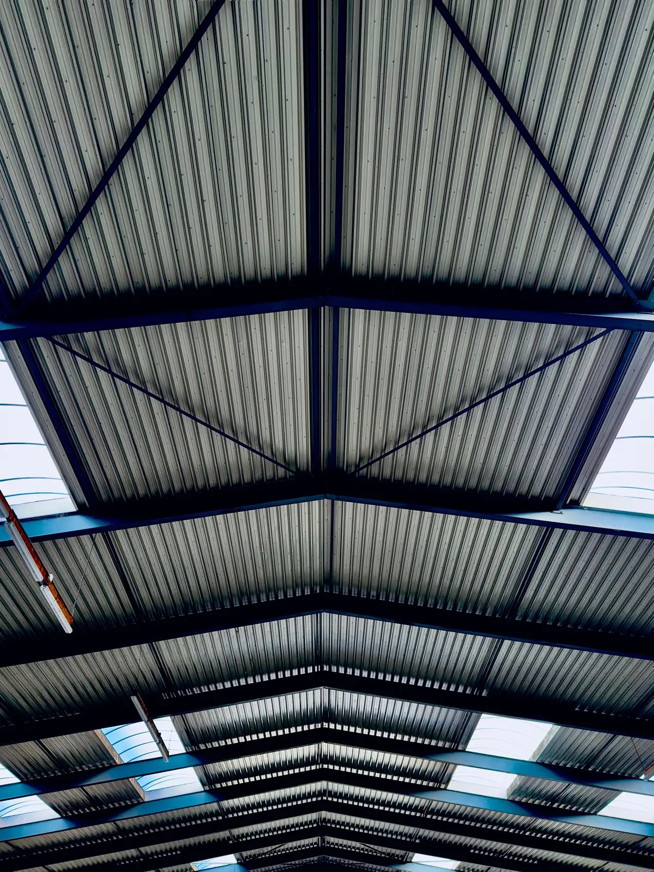 Roof trusses under a metal panel roof